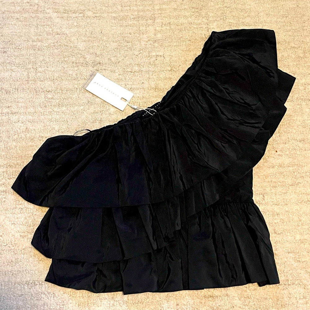 One-shoulder black ruffled top.